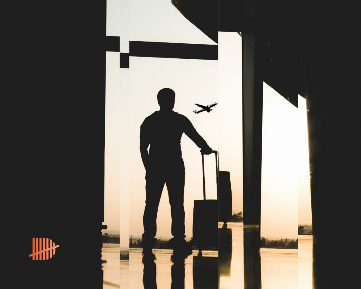 A man standing at the airport looking at planes signifying the relocation process to different tax jurisdictions