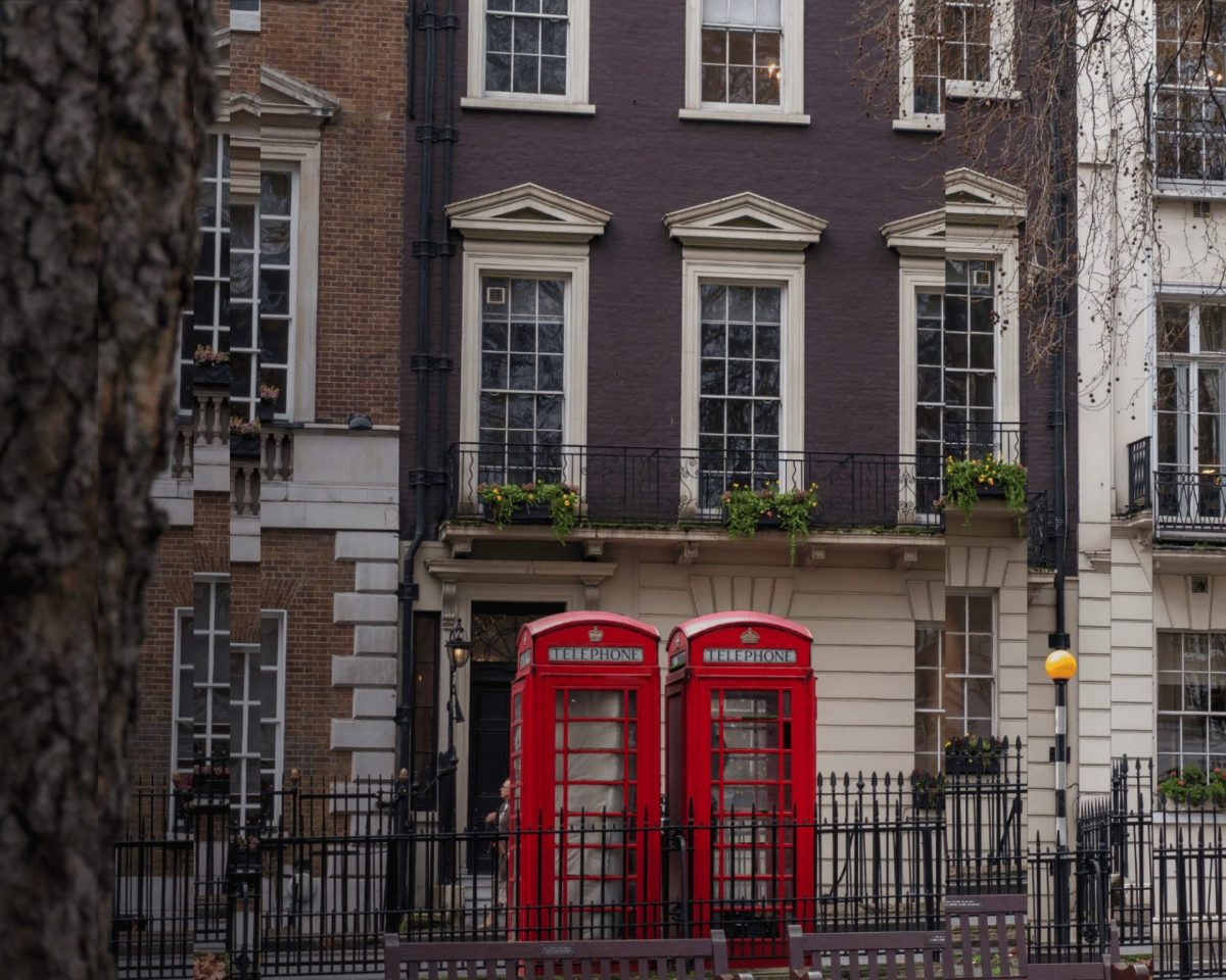 A picture of a London street with two red phone boxes.